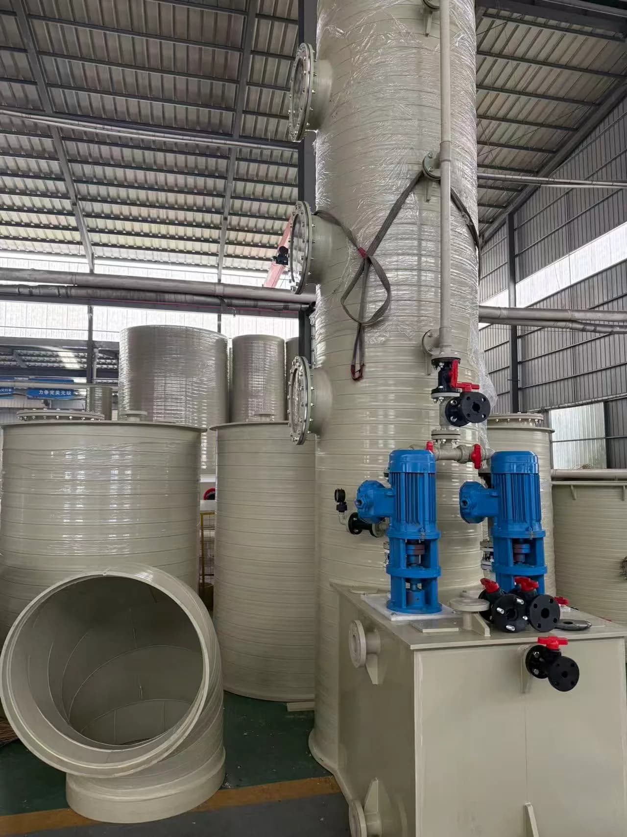 Plastic process equipment and blue pump assemblies viewed from the workshop side