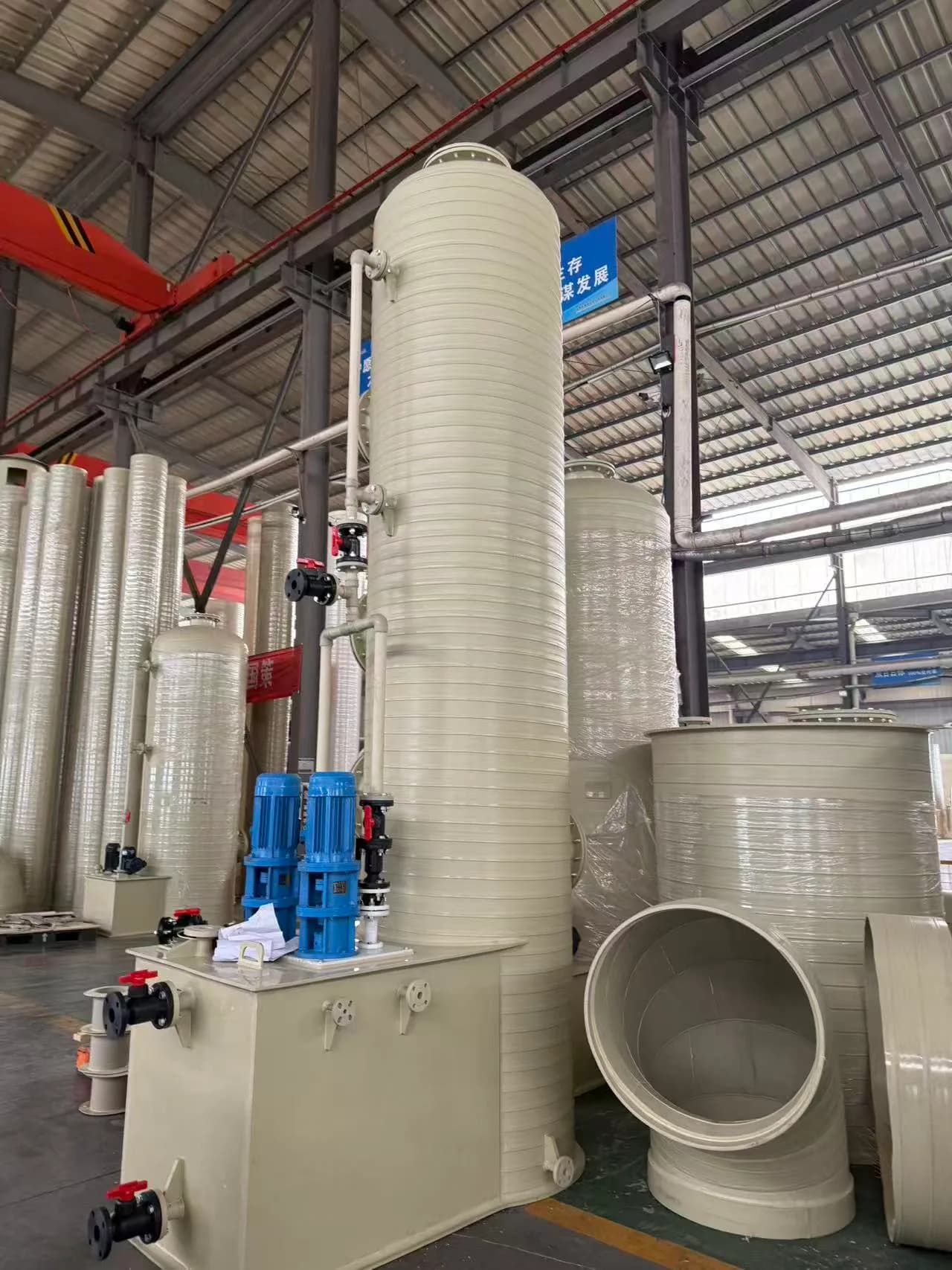 Tall plastic process equipment with pumps and external pipework