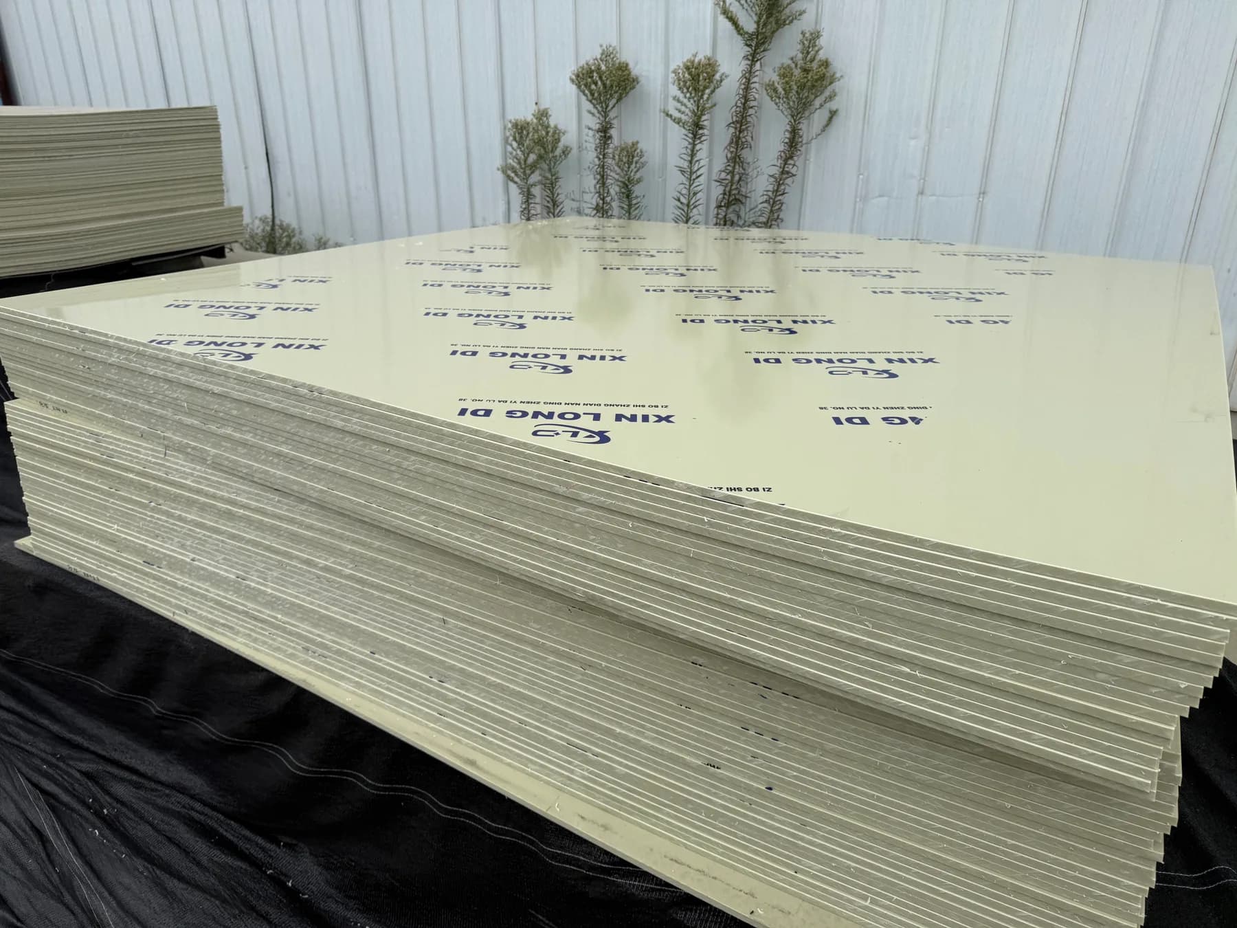 Stacked Xin Longdi plastic sheets with branded protective film