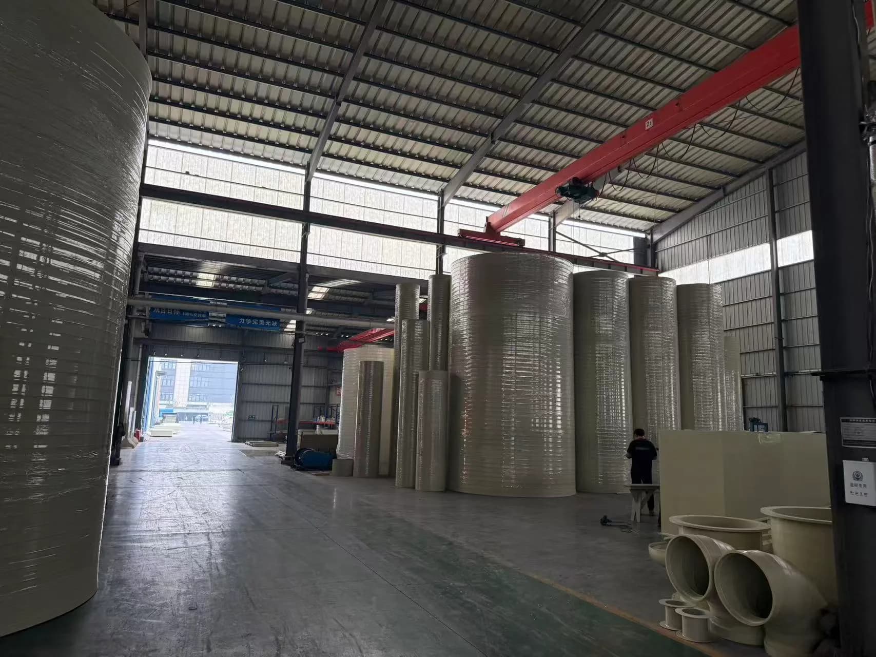 Large cylindrical plastic shells and fabricated assemblies inside the Xin Longdi workshop